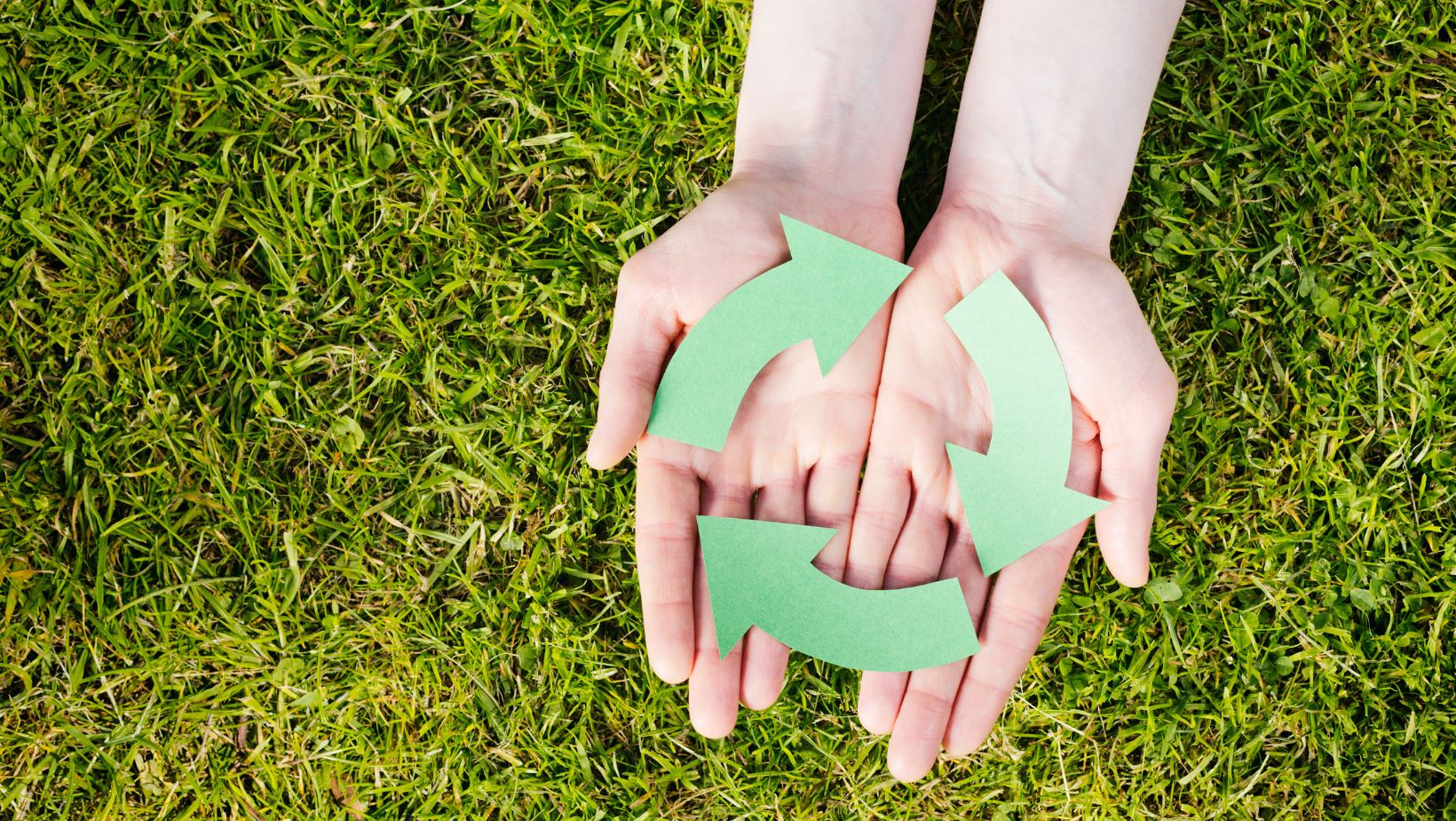 Hands holding a recycling symbol