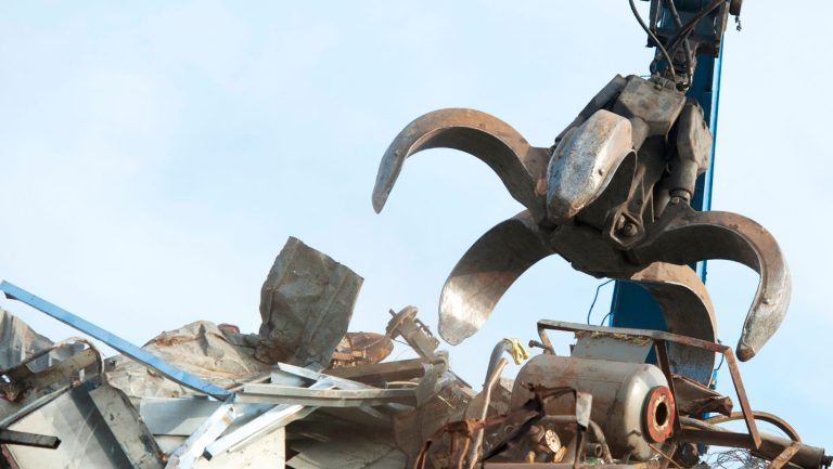 Crane picking up scrap metal