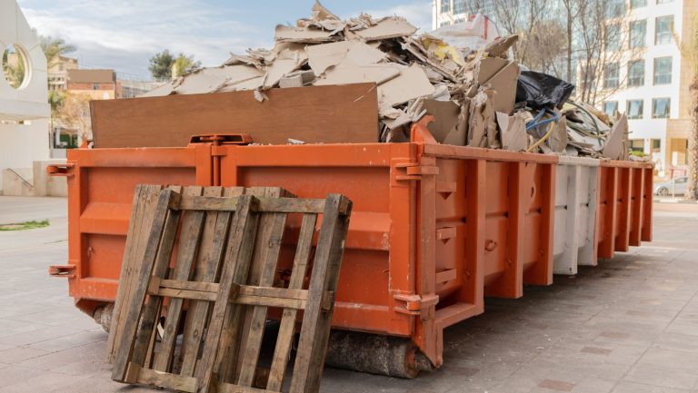 Roll off bin at a construction site with construction debris inside it