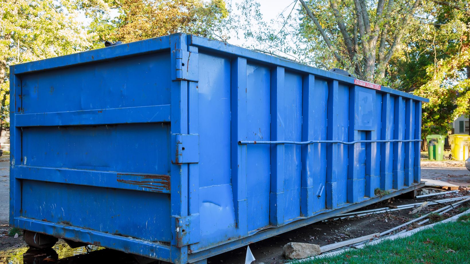 A blue roll-off bin.