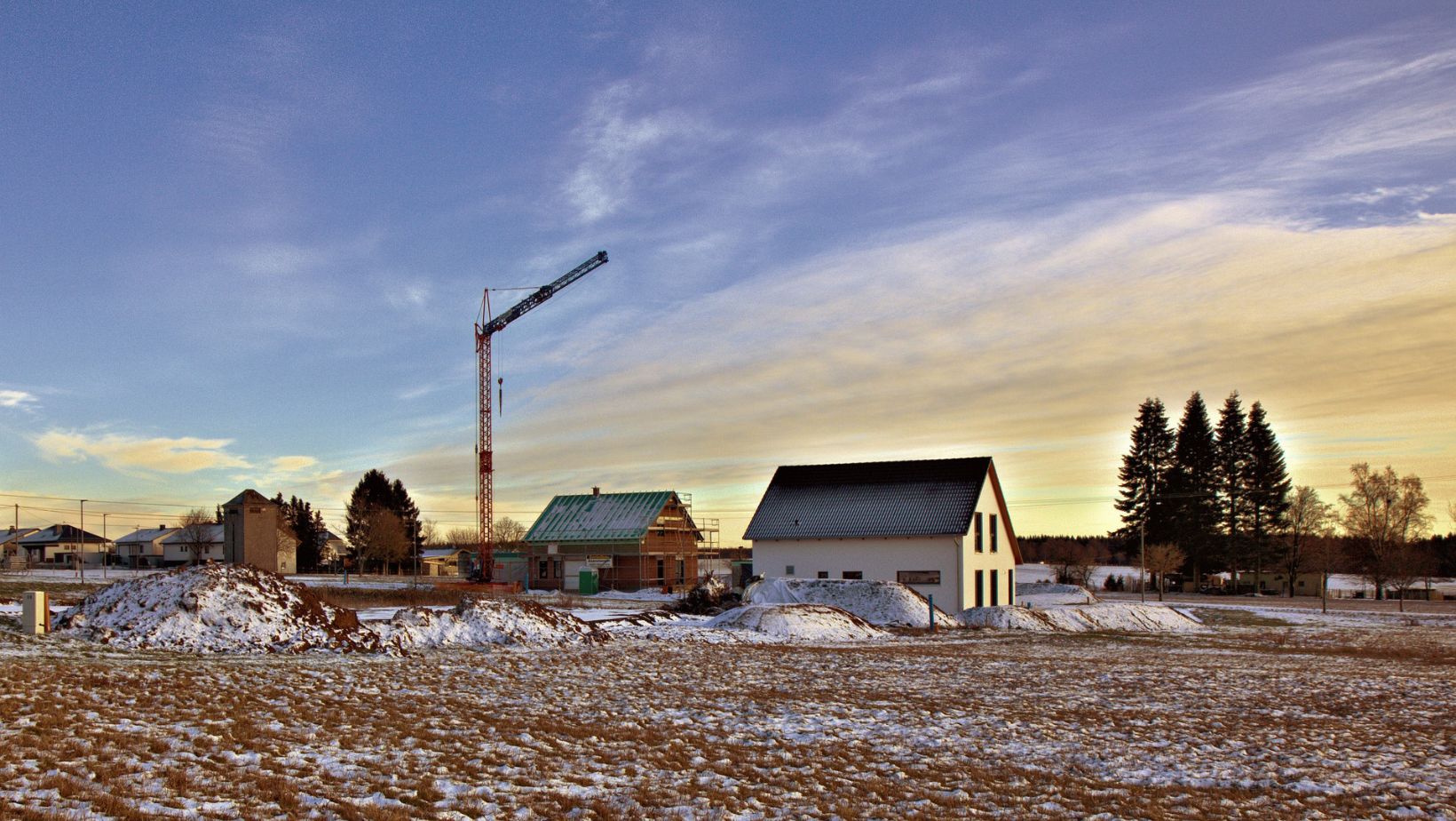 A crane at a construction site in winter.